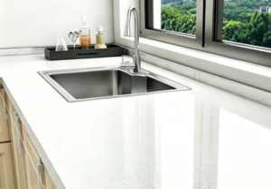 Modern kitchen counter and stainless steel sink sealed with mold-resistant neutral silicone sealant along backsplash joints