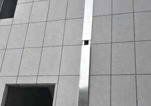 Heavy-duty elastomeric joint sealant sealing large structural expansion gaps on a concrete flat roof slab
