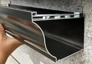 Waterproof elastomeric sealant applied along metal roof gutter seams and drainage downspout joints